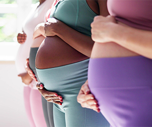 Pregnant women holding their bellies